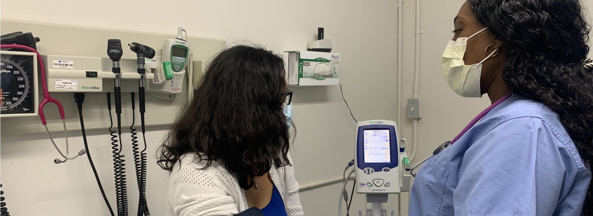 A nurse checking blood pressure of a patient