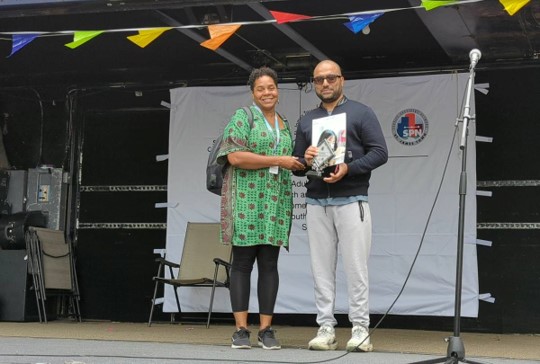 Hafiz Munir (Right) receiving the award for Tim Hortons from Tamara Este (Left)